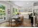 Bright dining area features a dining table, chairs, and cabinetry with granite countertops and stainless appliances at 1006 Wellington Ave, Indian Land, SC 29707