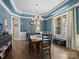 Elegant dining room featuring wainscoting, a chandelier, and natural light from the windows at 1006 Wellington Ave, Indian Land, SC 29707