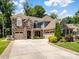Beautiful stone and siding home with well-manicured landscaping and a spacious driveway at 1006 Wellington Ave, Indian Land, SC 29707