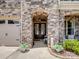 Charming home entrance with stone archway, double doors and manicured flower beds at 1006 Wellington Ave, Indian Land, SC 29707