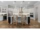 Open kitchen featuring a large island with bar seating, stainless appliances, and pendant lighting at 1006 Wellington Ave, Indian Land, SC 29707