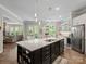Open-concept kitchen with a large island, stainless appliances, and seamless flow to the living spaces at 1006 Wellington Ave, Indian Land, SC 29707