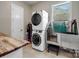 Functional laundry room with stacked washer/dryer, a utility sink, and ample counter space at 1006 Wellington Ave, Indian Land, SC 29707