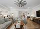 Open-concept living room with hardwood floors, comfortable sofas, and a view of the staircase and kitchen at 1006 Wellington Ave, Indian Land, SC 29707