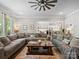 Spacious living room with hardwood floors, comfortable seating, and an open view to the kitchen at 1006 Wellington Ave, Indian Land, SC 29707