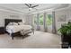Bright main bedroom with large windows, tray ceiling, ceiling fan and seating at 1006 Wellington Ave, Indian Land, SC 29707