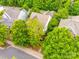 Aerial view of house surrounded by mature trees at 10407 Alvarado Way, Charlotte, NC 28277