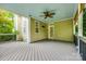 Covered back porch with ceiling fan, wooden flooring and siding at 10407 Alvarado Way, Charlotte, NC 28277