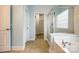 Bathroom featuring tile floors, a bathtub, and a shower at 10407 Alvarado Way, Charlotte, NC 28277