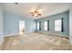 Spacious primary bedroom with carpet, fan, and natural light at 10407 Alvarado Way, Charlotte, NC 28277