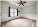 This bedroom features neutral paint, two windows, and a ceiling fan at 10407 Alvarado Way, Charlotte, NC 28277