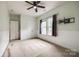The bedroom features neutral paint, two windows, and a ceiling fan at 10407 Alvarado Way, Charlotte, NC 28277