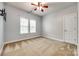 A bedroom with carpet, ceiling fan, and two windows at 10407 Alvarado Way, Charlotte, NC 28277