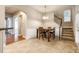 Dining area with wood floors, a staircase, and views into other living spaces at 10407 Alvarado Way, Charlotte, NC 28277