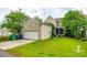 Detached garage with green lawn at 10407 Alvarado Way, Charlotte, NC 28277