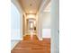 Elegant hallway with hardwood floors, arched doorways, and decorative wall paneling at 10407 Alvarado Way, Charlotte, NC 28277
