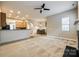 Spacious living room featuring a fireplace, neutral carpet, and an open floor plan at 10407 Alvarado Way, Charlotte, NC 28277