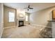 Inviting living room with a fireplace and neutral toned walls and carpeting at 10407 Alvarado Way, Charlotte, NC 28277
