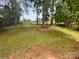 Expansive backyard with mature trees and lawn, creating a serene and private outdoor space at 10518 Fairway Ridge Rd, Charlotte, NC 28277