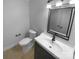 Cozy bathroom with a single sink vanity and toilet at 10518 Fairway Ridge Rd, Charlotte, NC 28277