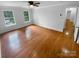 Bright bedroom featuring hardwood floors, two windows, and ample natural light at 10518 Fairway Ridge Rd, Charlotte, NC 28277