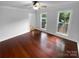 Spacious bedroom with hardwood floors and two large windows, offering plenty of natural light at 10518 Fairway Ridge Rd, Charlotte, NC 28277