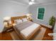 Bright bedroom showcasing hardwood floors, a comfortable bed, and soft, natural light at 10518 Fairway Ridge Rd, Charlotte, NC 28277