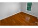 Bedroom featuring hardwood floors, a single window, and blank walls ready for your personal touch at 10518 Fairway Ridge Rd, Charlotte, NC 28277
