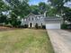 Charming two-story home with grey siding, black front door, and a well-manicured front yard at 10518 Fairway Ridge Rd, Charlotte, NC 28277