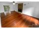 Spacious living room boasting hardwood floors and a brick fireplace ready for your personal touches at 10518 Fairway Ridge Rd, Charlotte, NC 28277