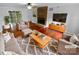 A modern living room featuring wood floors, a brick fireplace, and comfortable seating with neutral decor at 10518 Fairway Ridge Rd, Charlotte, NC 28277