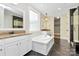 Elegant bathroom with dual vanities, soaking tub, walk-in shower, and access to the closet at 11052 Preservation Park Dr, Charlotte, NC 28214