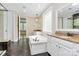 Bright bathroom with dual vanities, soaking tub, and walk-in shower at 11052 Preservation Park Dr, Charlotte, NC 28214