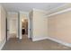 Bedroom featuring neutral walls, carpet, and access to an ensuite bathroom at 11052 Preservation Park Dr, Charlotte, NC 28214