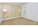 A cozy bedroom featuring a statement wall, and carpet floors at 11052 Preservation Park Dr, Charlotte, NC 28214