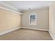 Neutral bedroom featuring a window with blinds and a cozy carpet at 11052 Preservation Park Dr, Charlotte, NC 28214