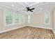 Bedroom with tray ceiling, fan, wood floors, neutral paint and plantation shutters at 11052 Preservation Park Dr, Charlotte, NC 28214