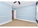 An empty bedroom with light blue walls and a window providing plenty of natural light at 11052 Preservation Park Dr, Charlotte, NC 28214