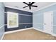 Bedroom with two-tone walls and natural light at 11052 Preservation Park Dr, Charlotte, NC 28214