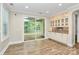 Bright breakfast nook with outdoor access and custom built-in cabinets with granite countertop at 11052 Preservation Park Dr, Charlotte, NC 28214