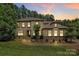 Stunning two-story home featuring stone accents, manicured landscaping, and a welcoming entrance at 11052 Preservation Park Dr, Charlotte, NC 28214