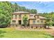 Beautiful two-story home with stone accents, lush landscaping, and inviting walkway at 11052 Preservation Park Dr, Charlotte, NC 28214