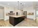 Beautiful kitchen featuring a central island, stainless appliances, and custom cabinetry at 11052 Preservation Park Dr, Charlotte, NC 28214