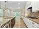 Spacious kitchen features stainless appliances, an island with dark cabinets, granite counters, and a deck view at 11052 Preservation Park Dr, Charlotte, NC 28214