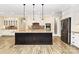 Spacious kitchen with a large center island, modern appliances, and custom cabinetry at 11052 Preservation Park Dr, Charlotte, NC 28214