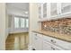 Kitchen area featuring custom cabinets, granite counters, stainless appliances and an opening to the dining room at 11052 Preservation Park Dr, Charlotte, NC 28214
