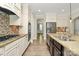 A kitchen boasts custom cabinets, stainless appliances, granite countertops and an island with dark cabinets at 11052 Preservation Park Dr, Charlotte, NC 28214