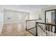 Upstairs landing with hardwood floors and views of the home at 11052 Preservation Park Dr, Charlotte, NC 28214