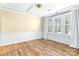 Bright living room featuring wood floors, wainscoting, and large windows with ample natural light at 11052 Preservation Park Dr, Charlotte, NC 28214