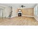Living room has wood floors, a fireplace, grasscloth wallpaper, natural light, and a ceiling fan at 11052 Preservation Park Dr, Charlotte, NC 28214